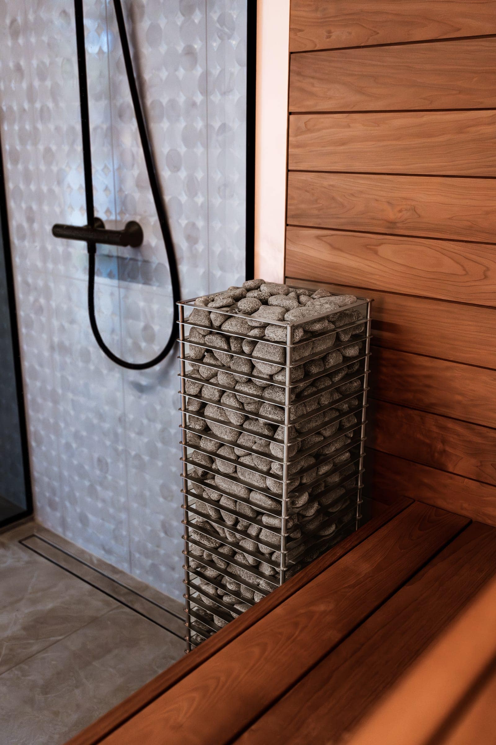 HUUM CLIFF next to a wooden bench and a glass shower wall