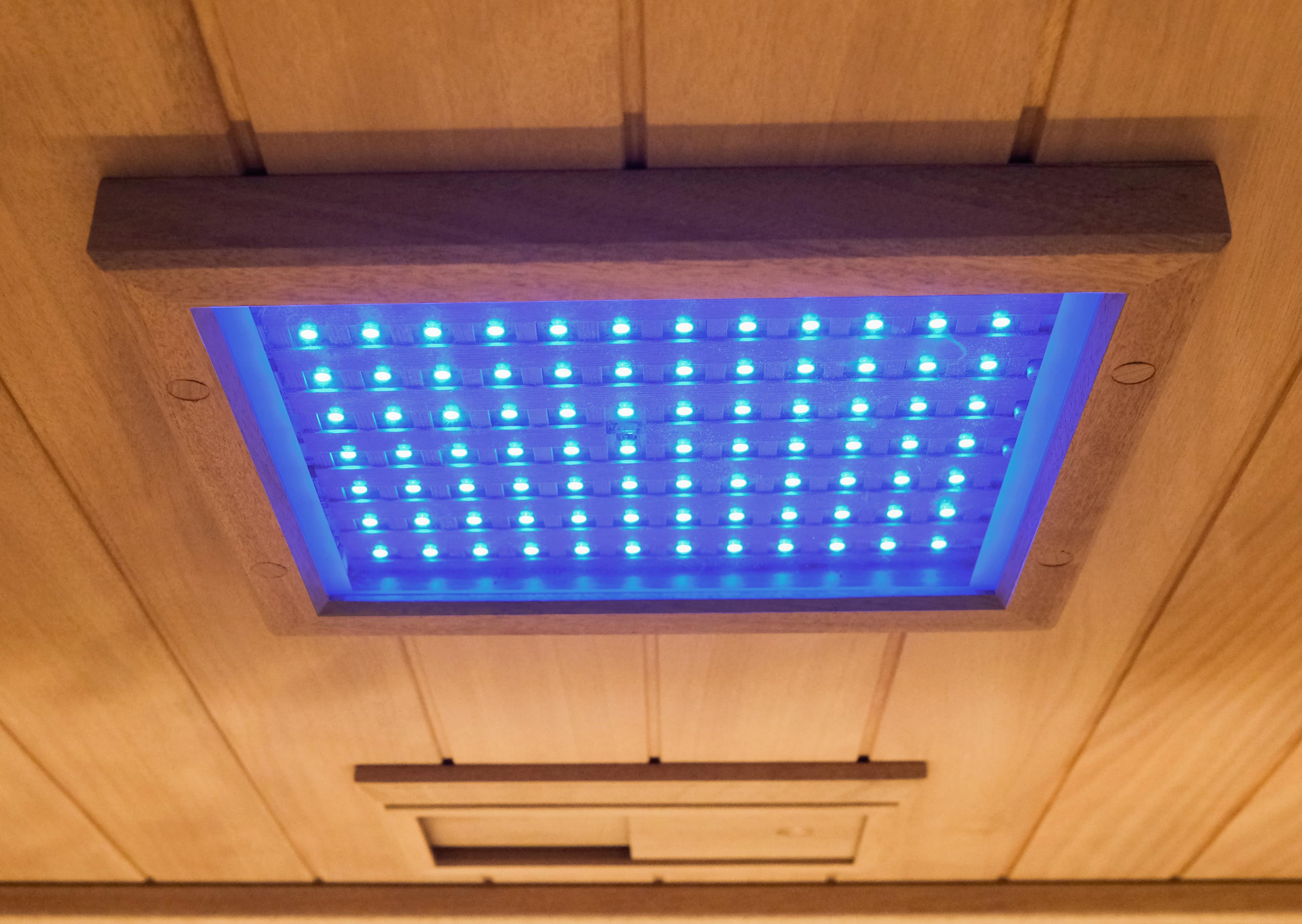 Blue LED chromotherapy panel set into the wooden ceiling of a Clearlight Premier sauna